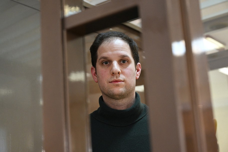 US journalist Evan Gershkovich, arrested on espionage charges, looks out from inside a defendants' cage before a hearing to consider an appeal on his extended pre-trial detention, at the Moscow City Court in Moscow on February 20, 2024. Wall Street Journal reporter Evan Gershkovich was detained last March on spying charges during a reporting trip to the Urals. (Photo by NATALIA KOLESNIKOVA / AFP) (Photo by NATALIA KOLESNIKOVA/AFP via Getty Images)
